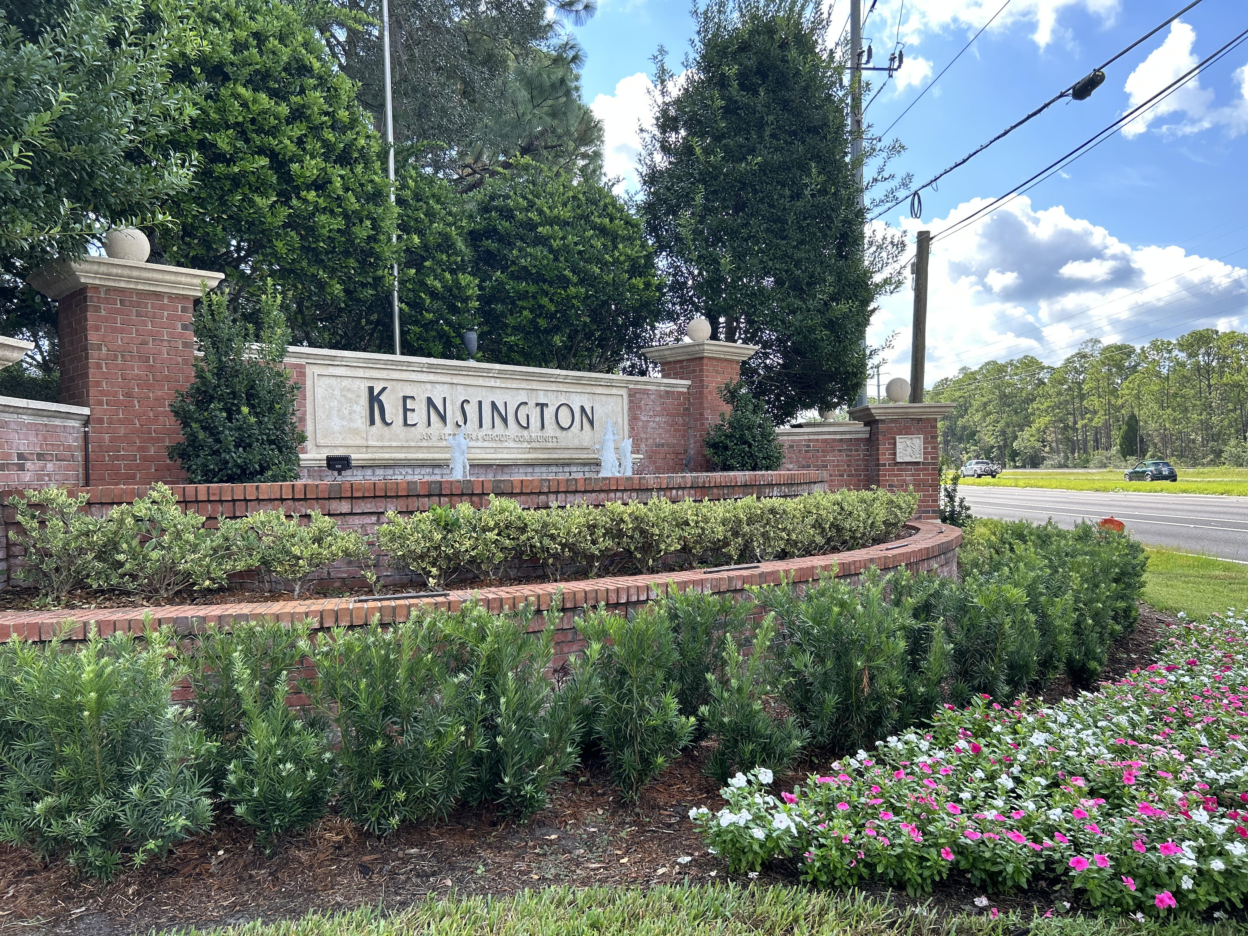 Kensington community entrance with lush green landscaping
